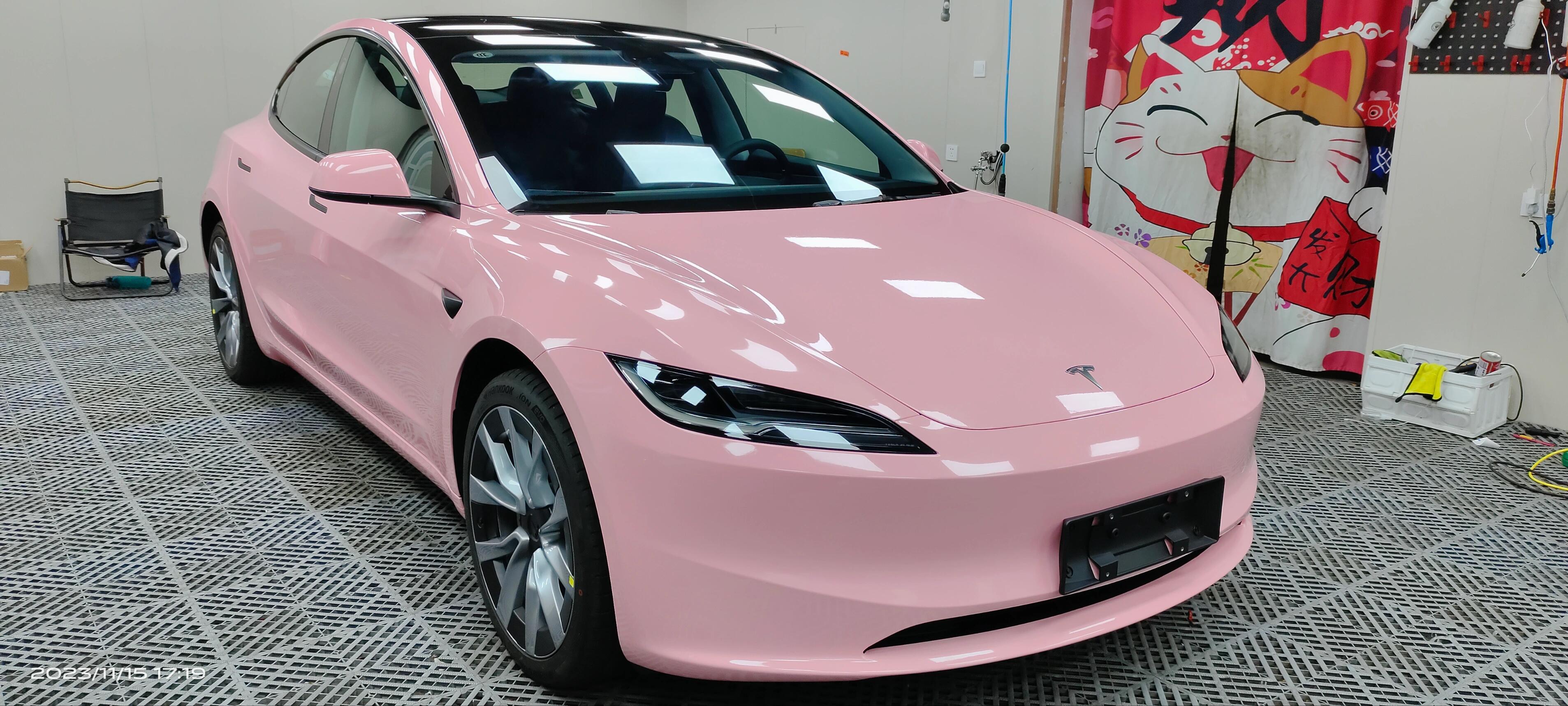 Pink Tesla Model 3 wrapped with WrapBug Pre-cut Tesla Vinyl Wrap Kit in a workshop