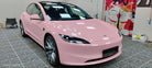 Pink Tesla Model 3 wrapped with WrapBug Pre-cut Tesla Vinyl Wrap Kit in a workshop