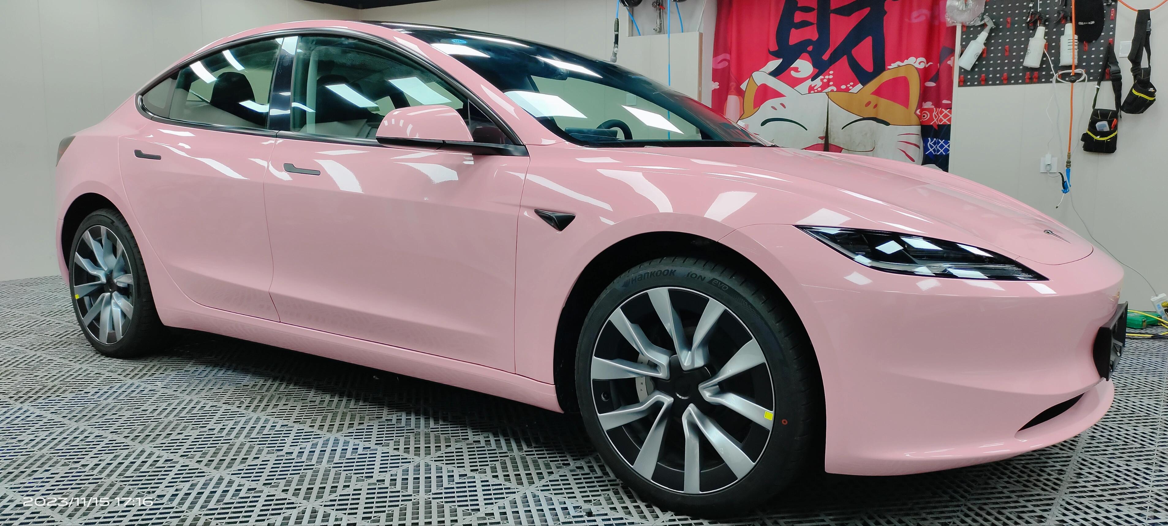 Pink Tesla Model 3 wrapped with WrapBug Pre-cut Tesla Vinyl Wrap Kit in a garage
