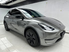 Tesla Model Y with gray glossy finish installed using Pre-cut Tesla Wrap Kit by WrapBug