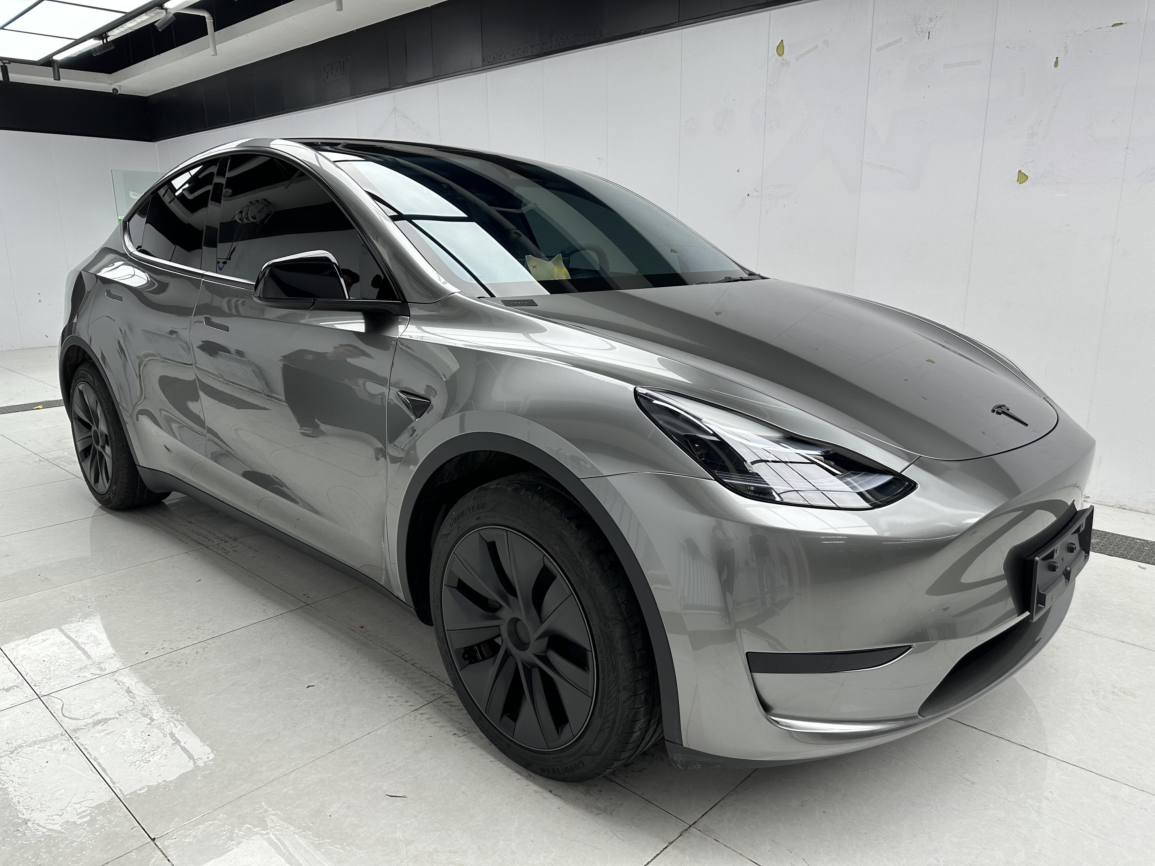 Tesla Model Y with gray glossy finish installed using Pre-cut Tesla Wrap Kit by WrapBug