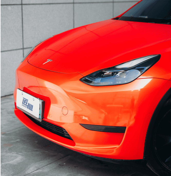 Red Tesla Model 3 front end wrapped with a Pre-cut Tesla Wrap Kit by WrapBug in a glossy finish