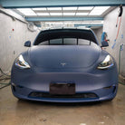 Matte blue tesla vinyl wrap on Tesla car in indoor garage by WrapBug