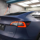 Tesla Model 3 with matte blue tesla vinyl wrap highlighting sleek rear design and taillights