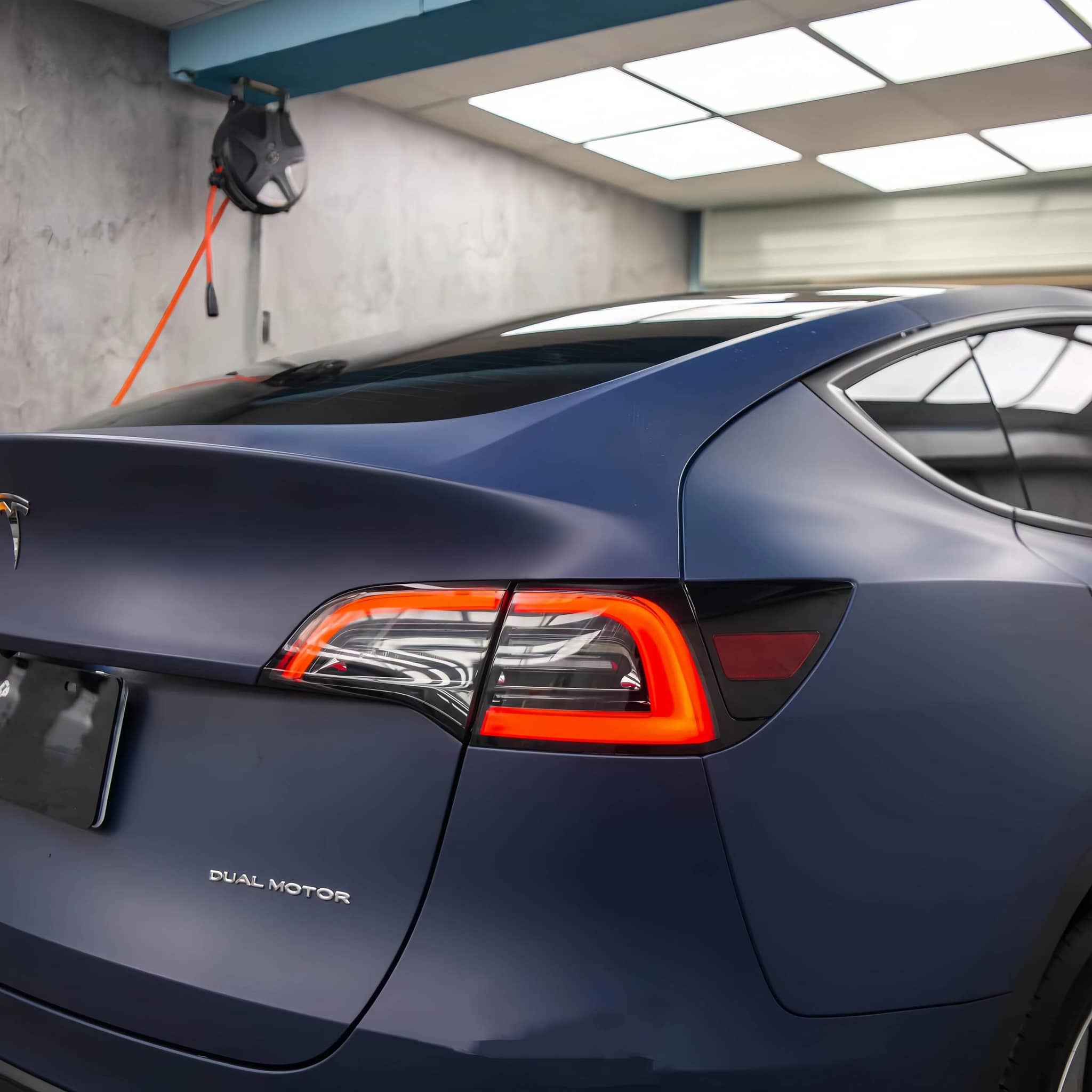 Tesla Model 3 with matte blue tesla vinyl wrap highlighting sleek rear design and taillights
