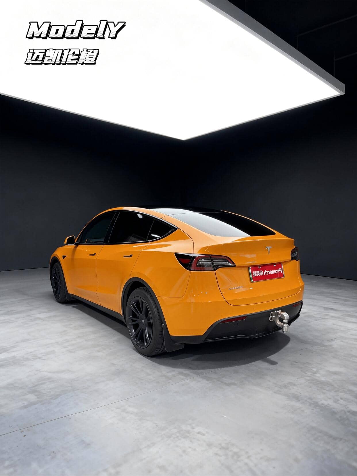 Orange Tesla Model Y featuring a Pre-cut Tesla Wrap Kit by WrapBug in a studio setting