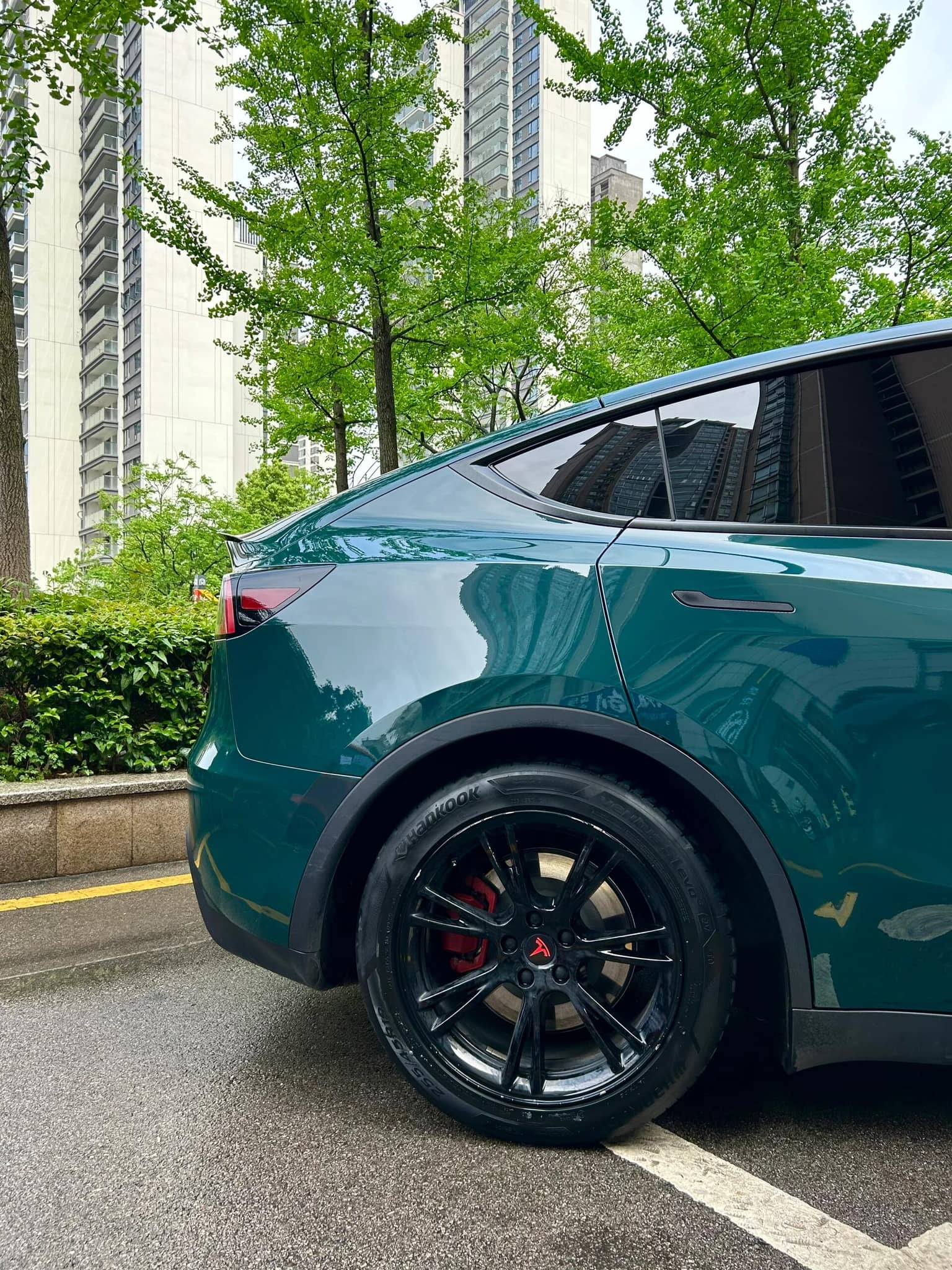 Tesla Model Y rear side wrapped with WrapBug Pre-cut Tesla Vinyl Wrap Kit in glossy green finish