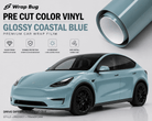 Pre-cut Tesla Vinyl Wrap Kit in glossy coastal blue by WrapBug shown on blue Tesla SUV and vinyl roll