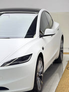 White Tesla Model 3 featuring Pre-cut Tesla Vinyl Wrap Kit by WrapBug on front side and wheel