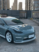 Gray Tesla Model 3 with a Pre-cut Tesla Vinyl Wrap Kit by WrapBug parked in an urban setting