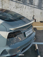 WrapBug pre-cut Tesla vinyl wrap kit applied on rear of gray Tesla with spoiler and ETH-ER X plate