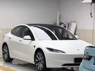 White Tesla Model 3 in garage showcasing a Pre-cut Tesla Vinyl Wrap Kit by WrapBug