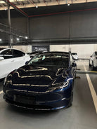 Dark blue Tesla parked indoors showcasing a Pre-cut Tesla Wrap Kit by WrapBug