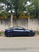 Black Tesla Model 3 parked on street with Pre-cut Tesla Wrap Kit by WrapBug applied