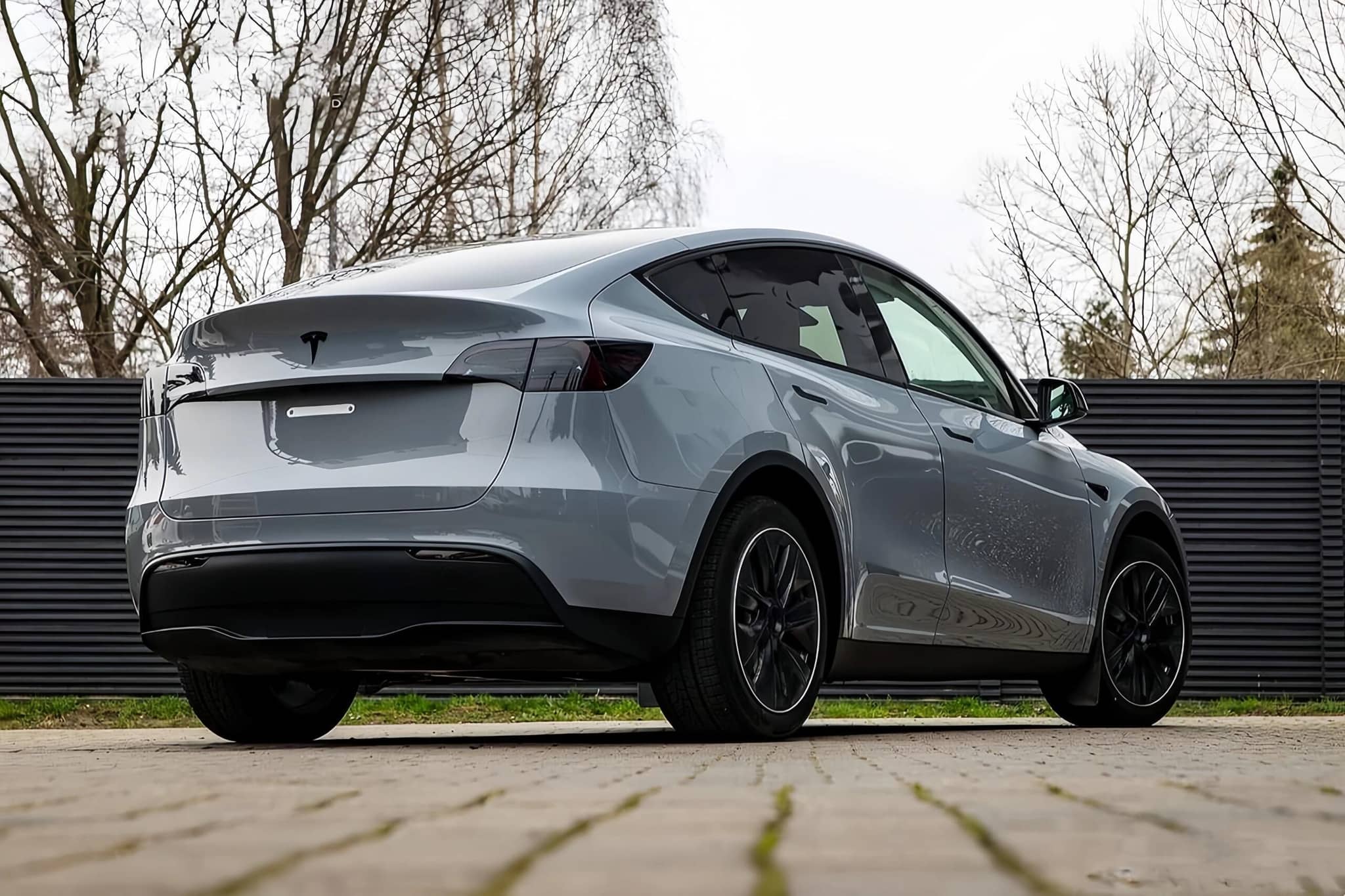 WrapBug matte gray Tesla Model Y electric SUV with black wheels parked outdoors