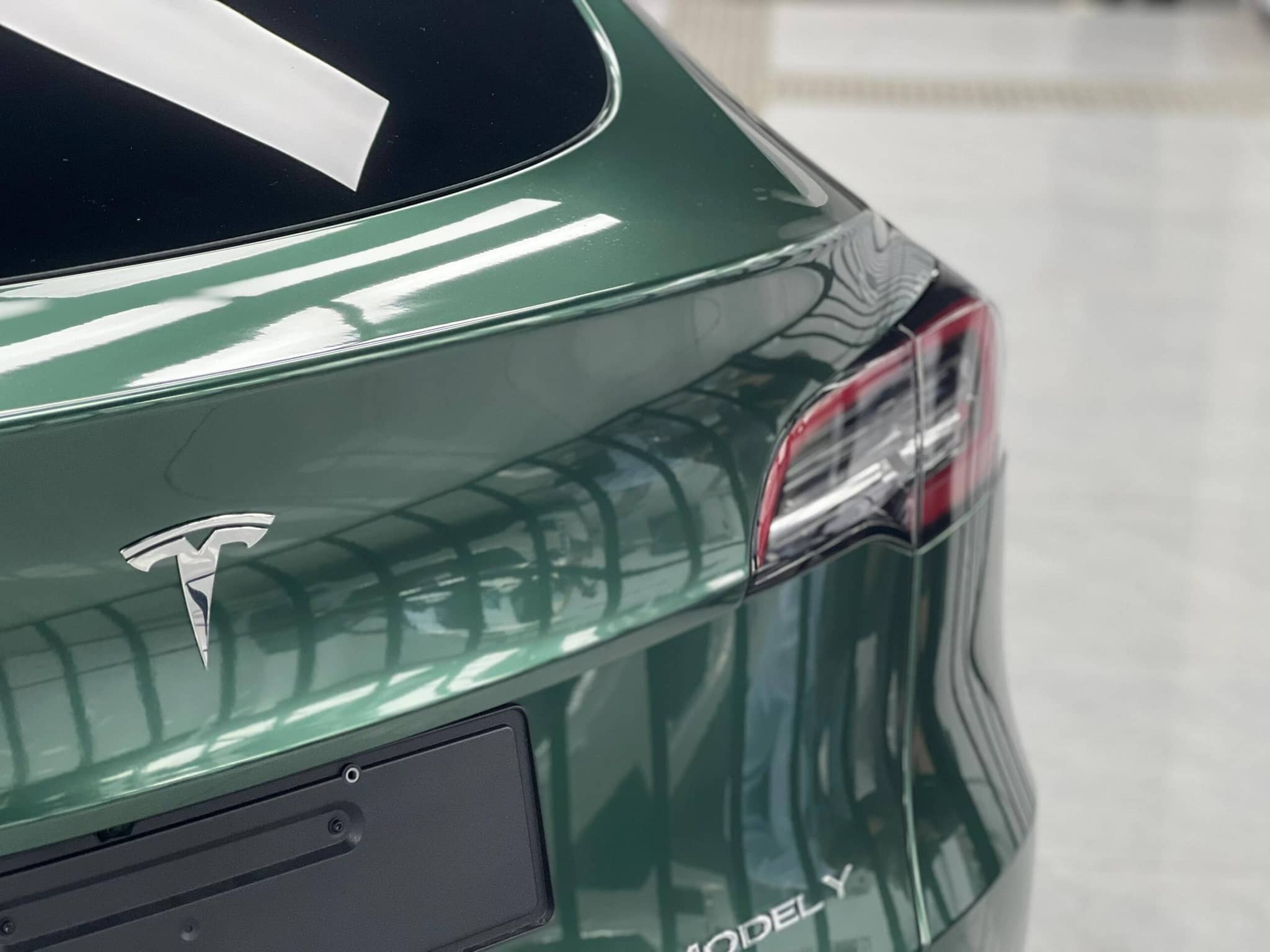 WrapBug pre-cut Tesla wrap kit applied to rear of green Tesla Model Y for smooth finish