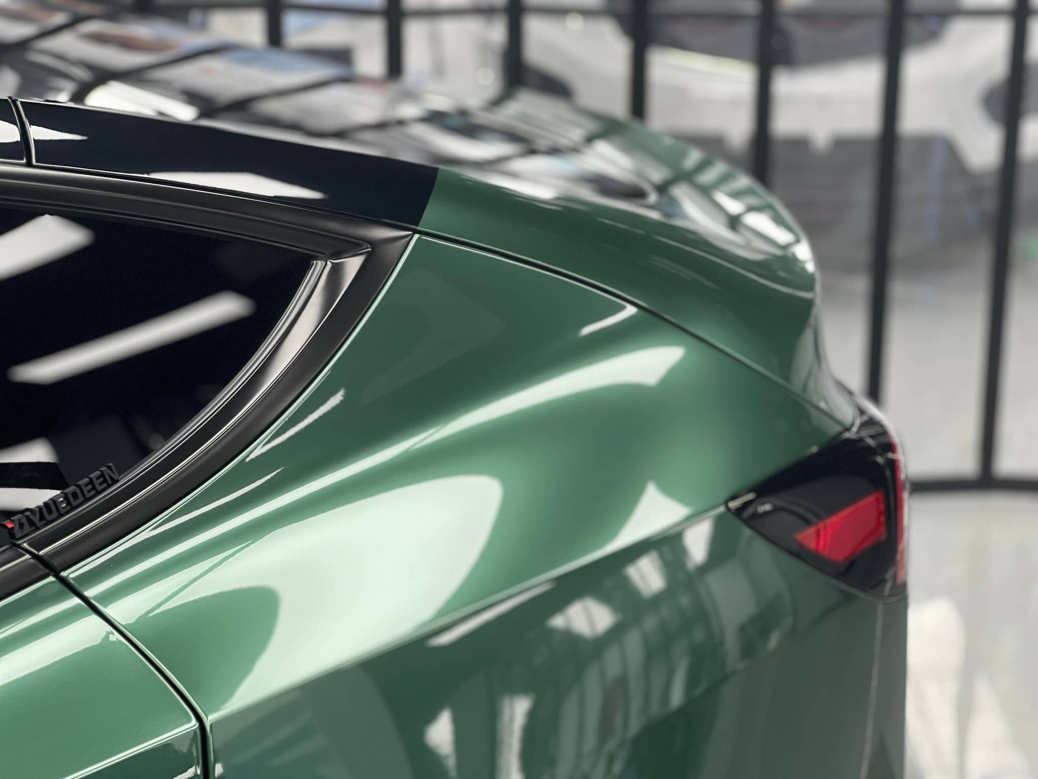 Glossy green Pre-cut Tesla Wrap Kit applied to rear side panel and window frame of Tesla car
